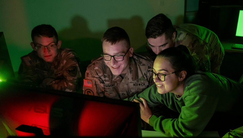 Students working together around a computer in the warroom.